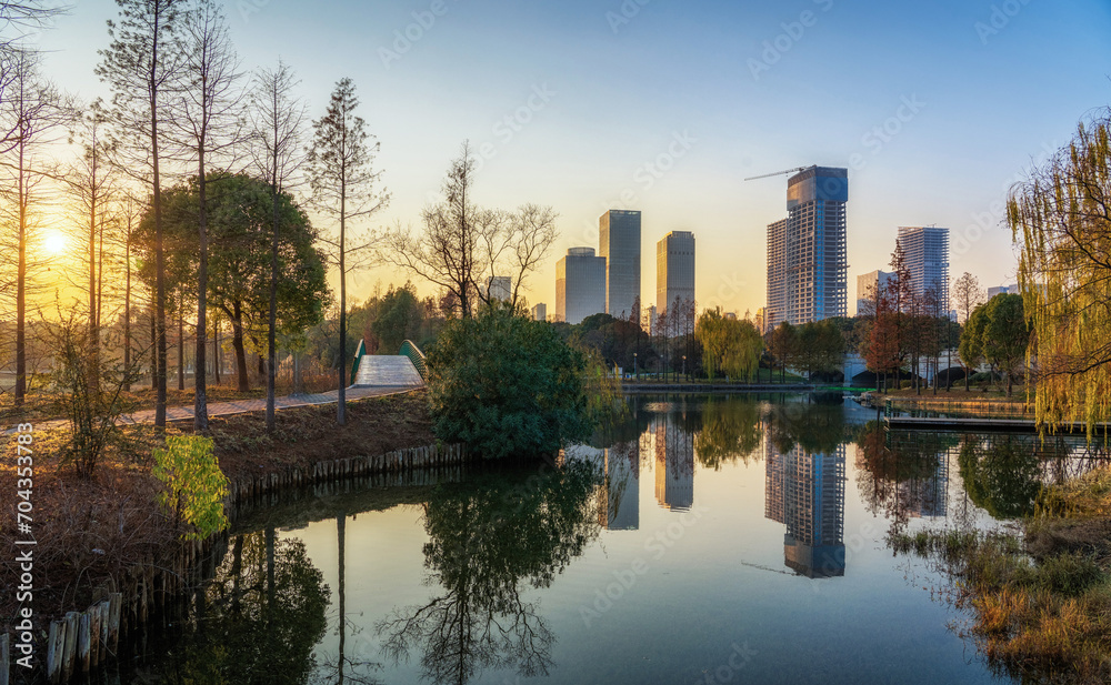 Sticker a modern city by the lake at sunset