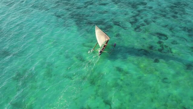 Aerial view by drone of locals sailing a boat.