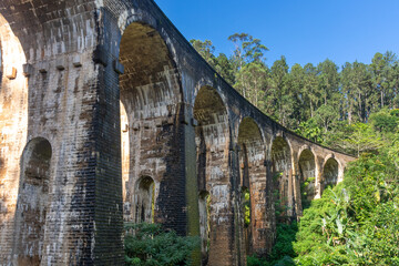 Fototapeta premium A beautiful nine-arch bridge near the city of Ella in Sri Lanka. Top view, aerial photography.