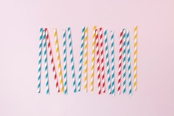Background make of colorful drinking straws on pink background. Ceative concept.