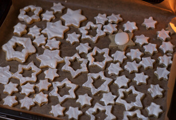 Handmade Christmas Cookies on the tray, on a sheet of baking paper
