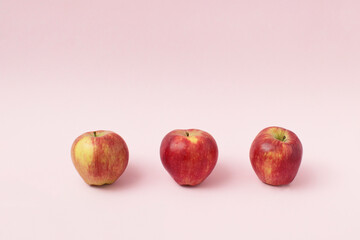Red apples on pink background. Minimal food concept.