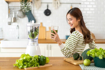 Portrait beauty healthy asian woman making green vegetables detox cleanse and green fruit smoothie...