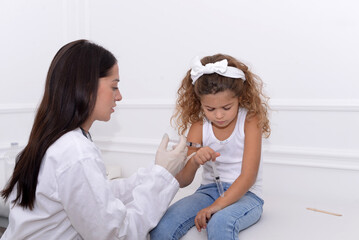 Child of preschool age receives a vaccine in the doctor's office