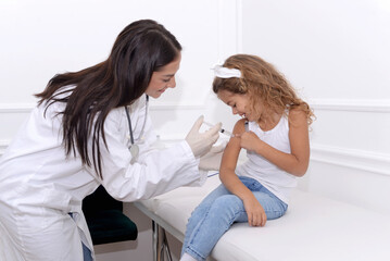 Child of preschool age receives a vaccine in the doctor's office