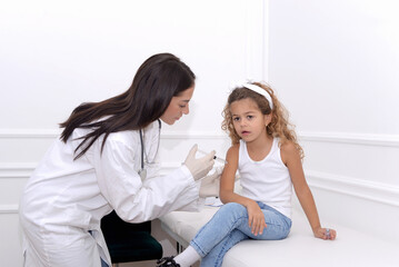 Child of preschool age receives a vaccine in the doctor's office