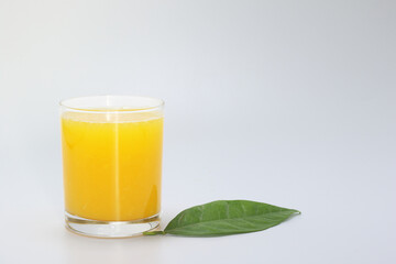 glass of orange juice and orange on white background