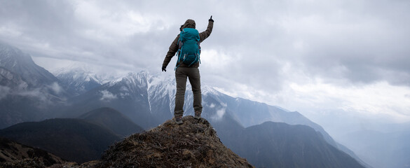 Woman hiker hiking at mountain top in tibet