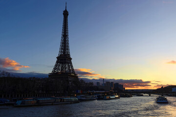 Fototapeta na wymiar View of Eiffel Tower and river Seine at sunset in Paris. Eiffel Tower is one of the most iconic landmarks of Paris