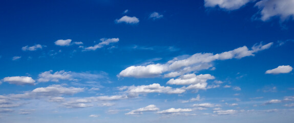A peaceful blue sky with white clouds.