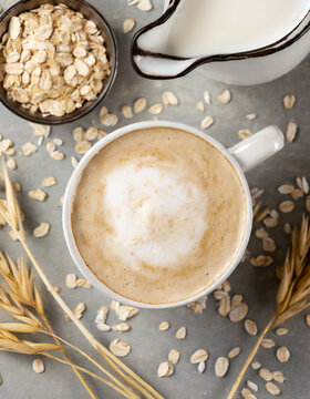 Cup of oat cappuccino decorated with oats shot from above