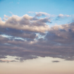 Clouds are highlighted by the sun’s rays, casting shadows and light.
