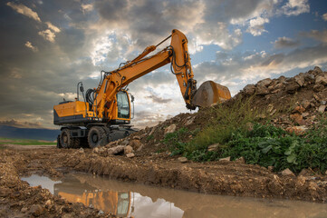 Excavator at a construction site, moving earth