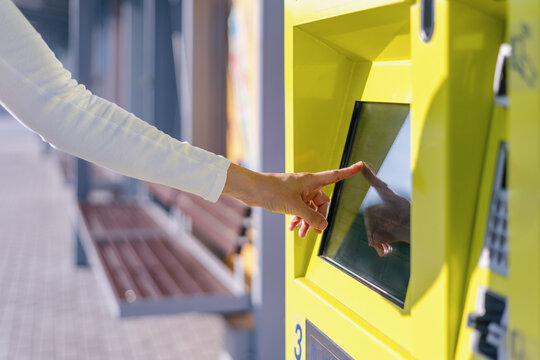 Selective focus on woman hand typing, choosing type of travel pass on atm