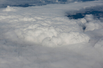 View of magnificent clouds and sky from above from an airplane.