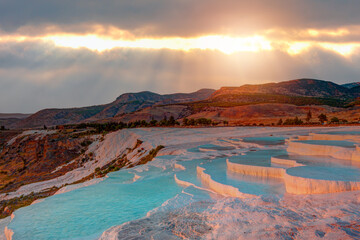 Natural travertine pools and terraces in Pamukkale at sunset ( Cotton castle) - Denizli,...