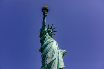 Fototapeta premium The Statue of Liberty with her crown holding her torch, democratic symbol of New York (USA) and the Big Apple, famous in Manhattan and the world.
