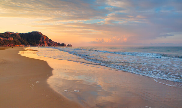 Beach of Cleopatra with sea and rocks of Alanya peninsula at sunset - Antalya, Turkey 