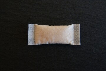 Nicotine pouch on a dark background. Snus tobacco product. High quality photo