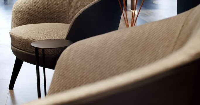 Close Up Fabric and Textile modern brown armchair and relax chair. Modern Minimalist Home. Elegance and Comfortable Home, Warm cozy. Modern beige armchair. Interior Detail. Modern textile chair.