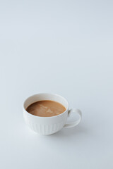 white cup with coffee with milk on a white background