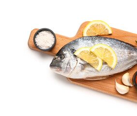 Wooden board with raw dorado fish and lemon on white background