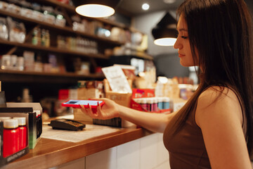 Contactless customer payment for a drink from a mobile phone in a cafe,