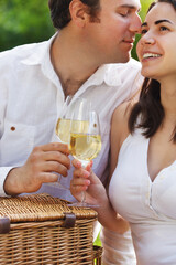 Young happy couple enjoying a glasses of white wine
