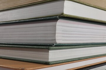 Stack of many different hardcover books as background, closeup