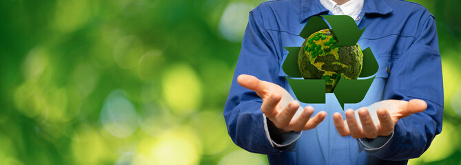 Engineer holding a green planet Earth with recycling symbol