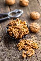 Peeled dried walnut kernels on wooden table.