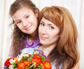 Portrait of happy mother and her little daughter