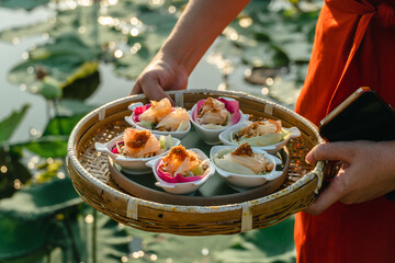 Miang Kham lotus petals-wrapped is a food that people is eaten as a snack. Lotus lotus petals are a...