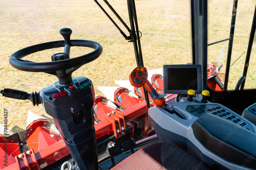 Poster unmanned autonomous harvester on the field. view from the cockpit.