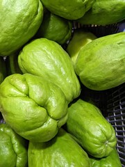 Green Sechium edule unripe on the basket grocery store. The photo is suitable to use for fruit and vegetable background and promotion content media.