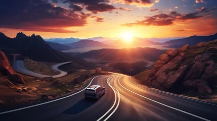 Foto op Canvas Car driving through a winding mountain road at sunset © duyina1990