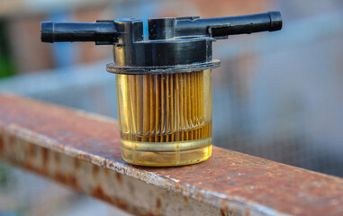 used car fuel filter. old car fuel filter close-up. blurred background. - obrazy, fototapety, plakaty