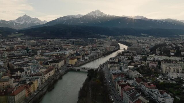 Innsbruck at Sunset time, Amazing Aerial Drone Shot of a Beautiful City in Winter, in Alps Mountains in Austria.