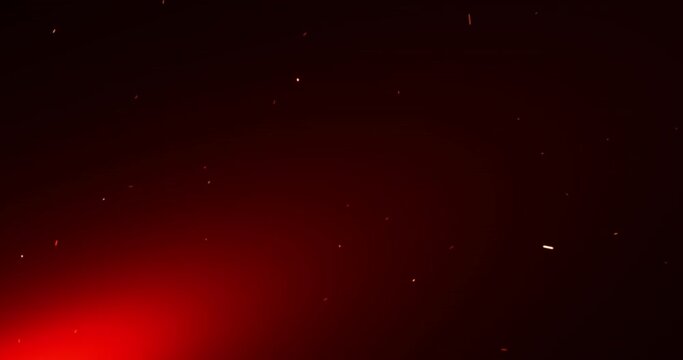 Orange sparks of an abstract campfire flying up and carried away by the wind. The red glow of the fire. Seamless looping animation.