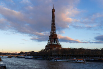 Fototapeta na wymiar View of Eiffel Tower and river Seine at sunset in Paris. Eiffel Tower is one of the most iconic landmarks of Paris