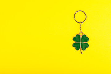 Clover keychain with key ring  on a colored background. Concepts for real estate and moving home or...