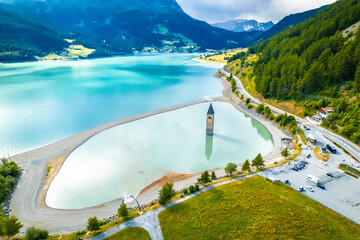 Curon Venosta. Submerged bell Tower in Graun im Vinschgau on Lake Reschen Alpine landscape aerial view - obrazy, fototapety, plakaty