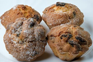 Four sweet cupcakes with raisins