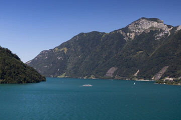 Obraz premium Beautiful summer view accross Lake Uri, an arm of Lake Lucerne. Looking towards Ingenbohl and Rigi Hochflue mountain in Switzerland. Swiss Alps landscape view with copy space.
