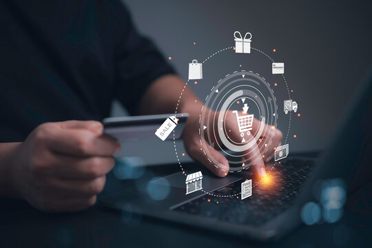Businessman use laptop with credit card in hand paying online banking transaction. E commerce virtual shopping interface global network.Online banking and digital marketing concept.