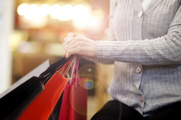 Close up of woman holding shopping bags