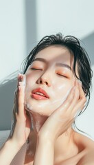 Naklejka premium Asian woman washing her perfect porcelain skin face in the morning with both hands