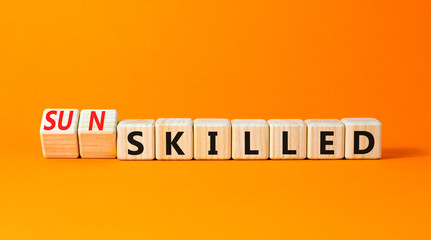 Sun skilled symbol. Concept words Skilled or Sun skilled on beautiful wooden blocks. Beautiful orange table orange background. Business sun skilled concept. Copy space.