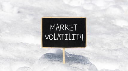 Market volatility symbol. Concept words Market volatility on beautiful black chalk blackboard. Chalkboard. Beautiful snow background. Business market volatility concept. Copy space.orange