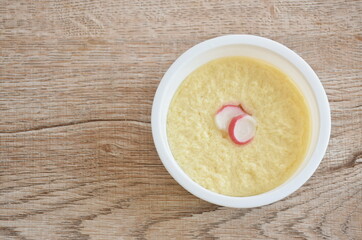 steamed egg with water topping slice crab stick in white plastic cup on table